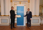 Regierungspräsident Axel Bartelt (links) überreicht die Kommunale Verdienstmedaille in Bronze an Jens Meyer, Oberbürgermeister der Stadt Weiden (rechts). 